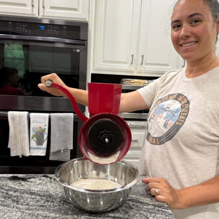 Tyla from Freshly Milled Recipes milling grain with her manual grain mill - Health Benefits of Freshly Milled Flour