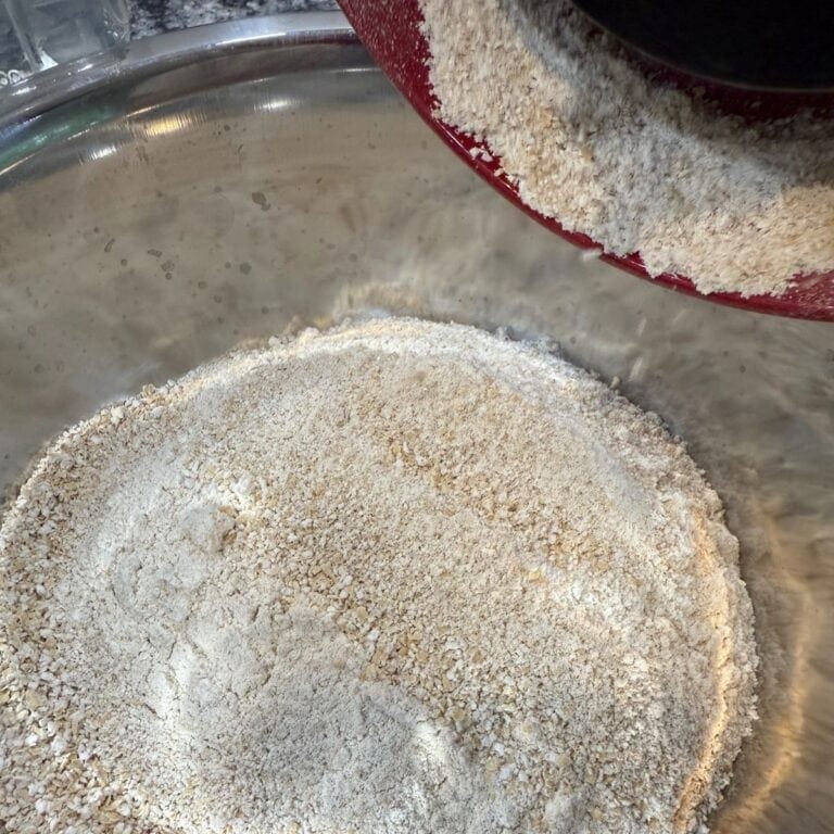 Freshly Milled Flour in a bowl coming out of a grain mill